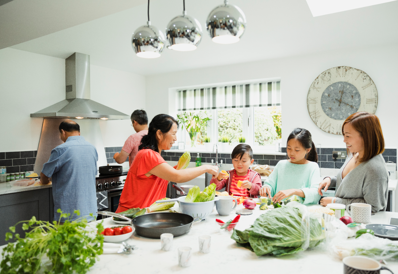 A family cooking together for a Christmas feast with elderly loved ones