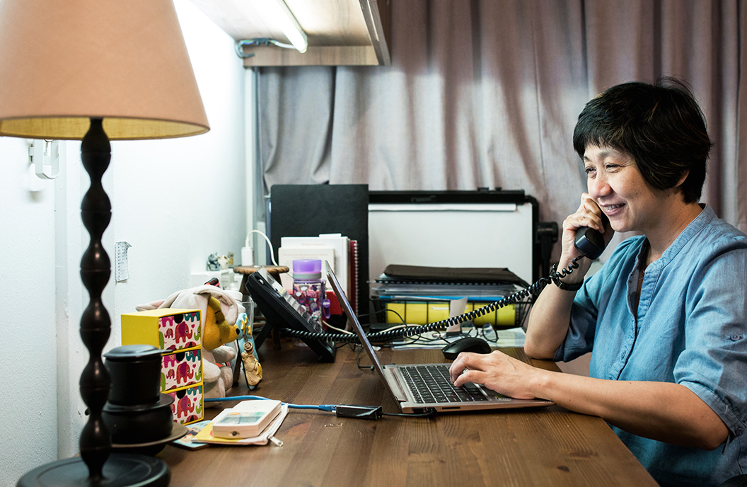 Ruth Chua, Executive Director of Counselling and Care Centre working at her desk
