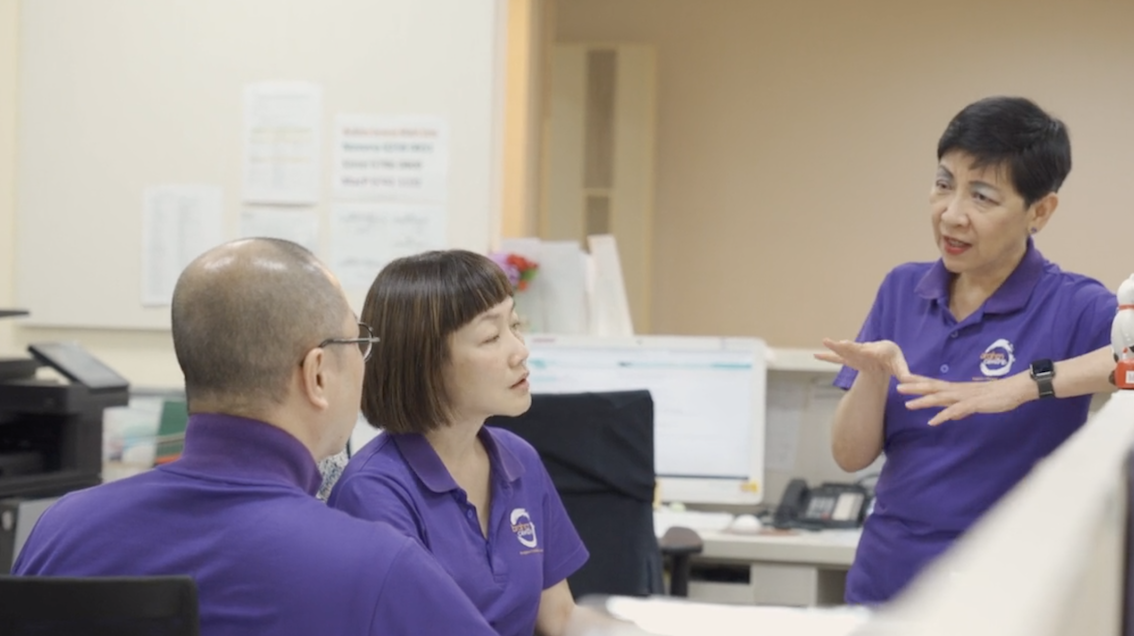 Angie having a discussion with her colleagues